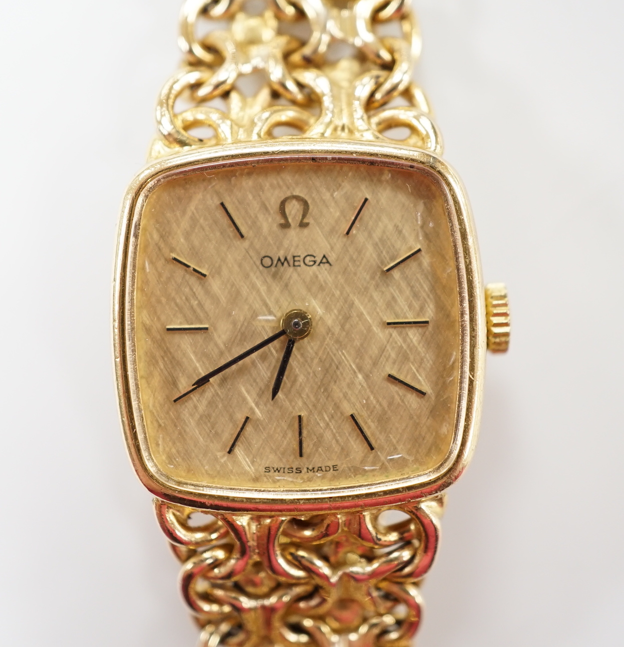 A lady's 1970's 9ct gold Omega manual wind wrist watch, on integral Omega 9ct gold bracelet, approximately 16cm, gross weight 28.1 grams.